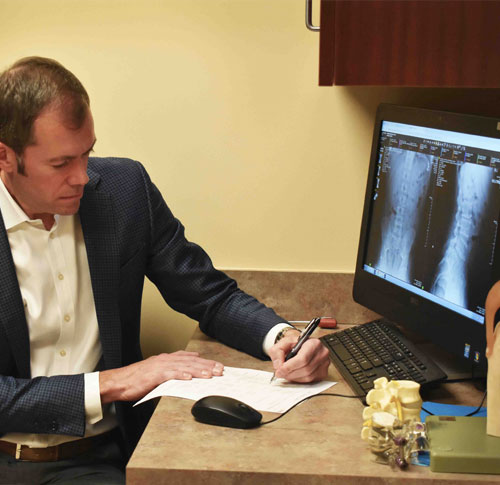 Stanton-taking-notes-in-clinic_Dean-Clore_lores
